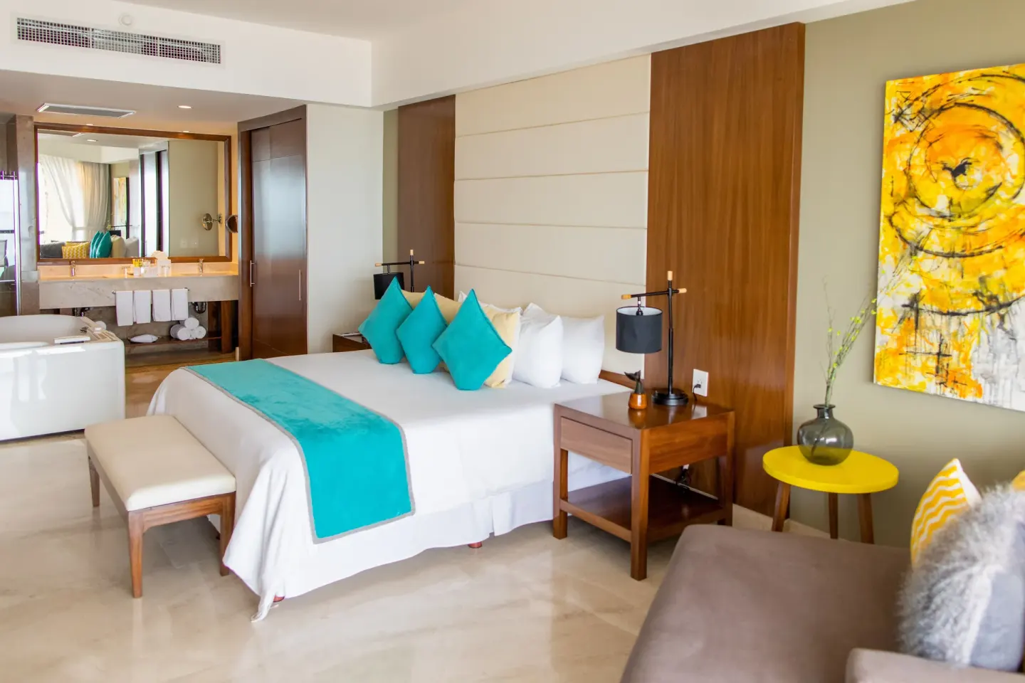 Altitude Presidential Suite king bed with sofa and vanity at Krystal Grand Los Cabos.