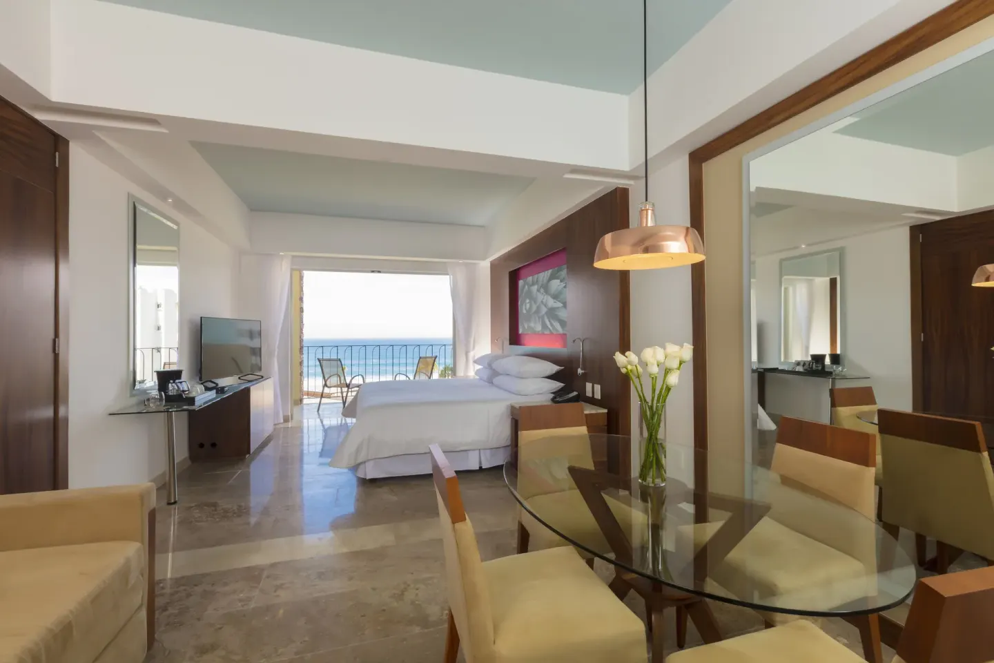 Junior Suite Ocean View with king bed and balcony beyond at Krystal Grand Los Cabos.