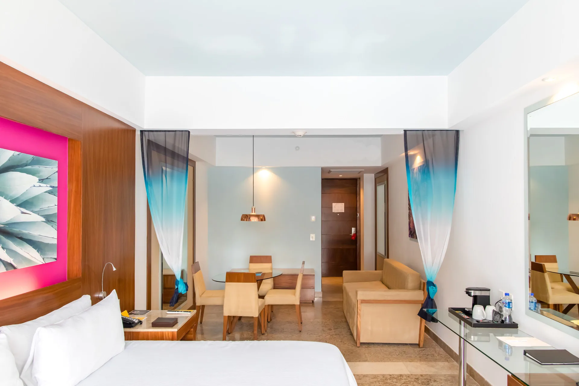 Junior Suite Ocean View with bed, dining table and sofa at Krystal Grand Los Cabos.