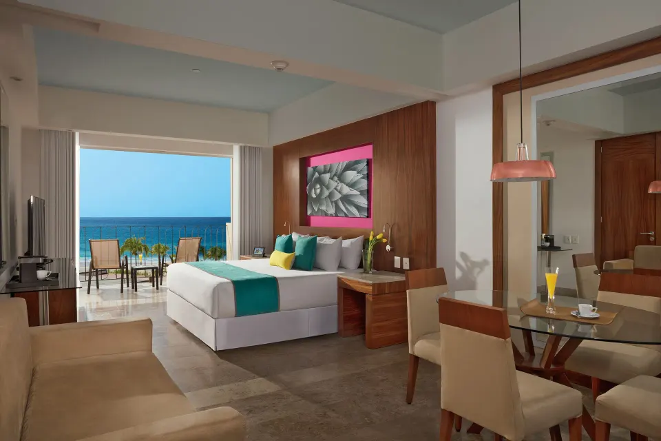 Junior Suite Ocean View king bed facing balcony and sea at Krystal Grand Los Cabos.