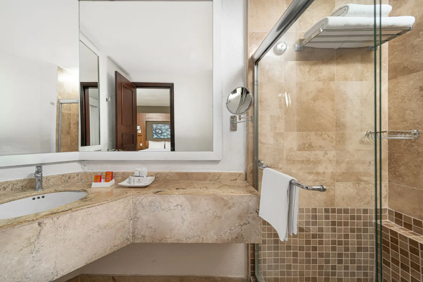 Suite Palmilla Ocean View bathroom with vanity and glass shower at Krystal Grand Los Cabos.