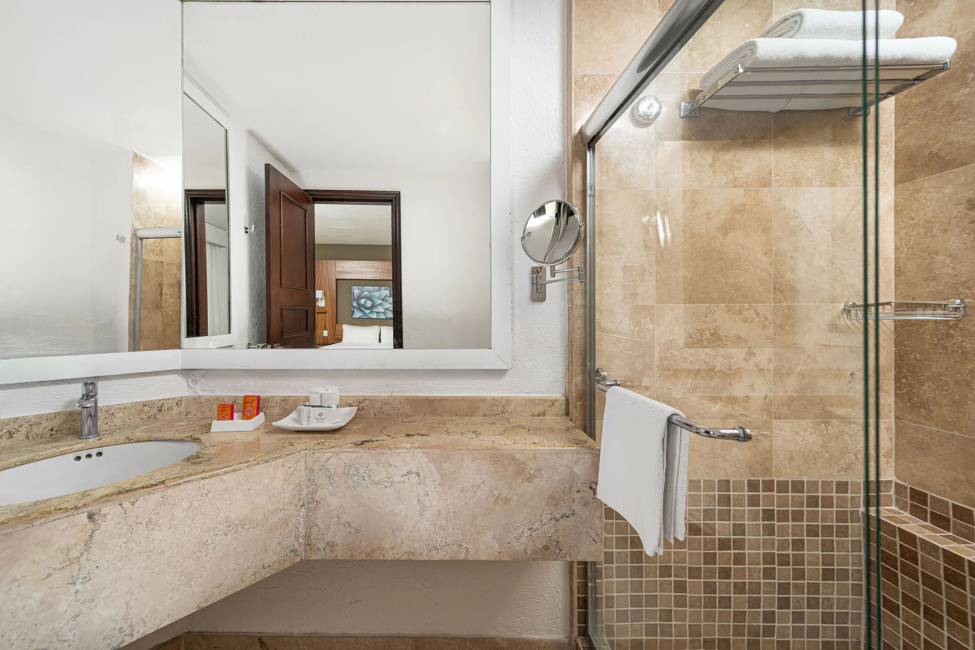 Suite Palmilla Ocean View bathroom with vanity and glass shower at Krystal Grand Los Cabos.