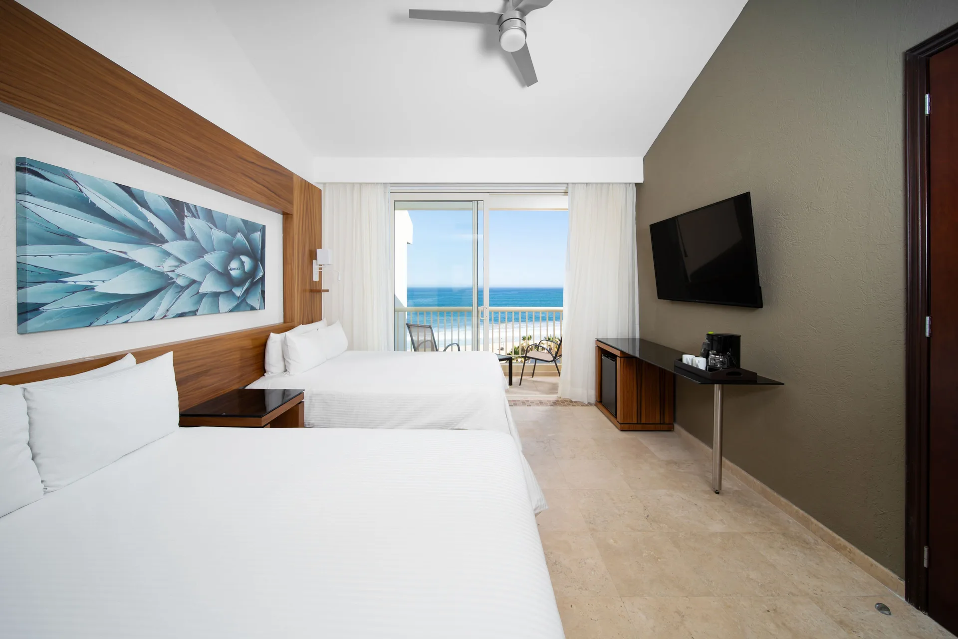 Suite Palmilla Ocean View at Krystal Grand Los Cabos with two beds, balcony seating, and Sea of Cortez views ideal for families on Palmilla Beach.