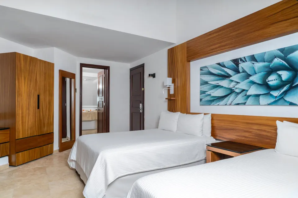 Suite Palmilla Ocean View bedroom with two beds at Krystal Grand Los Cabos.