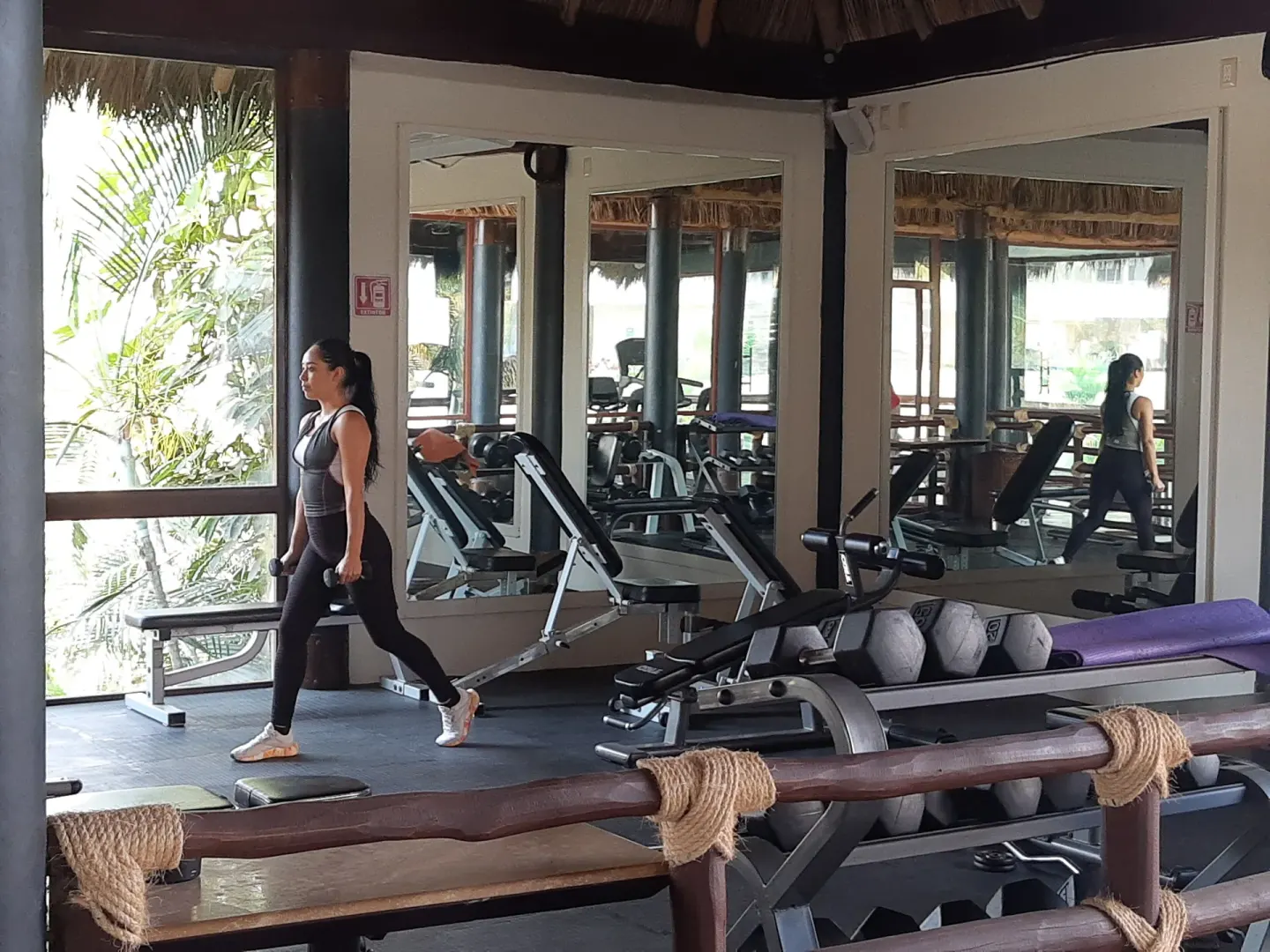 Fitness room with weights and exercise benches at Krystal Grand Nuevo Vallarta.