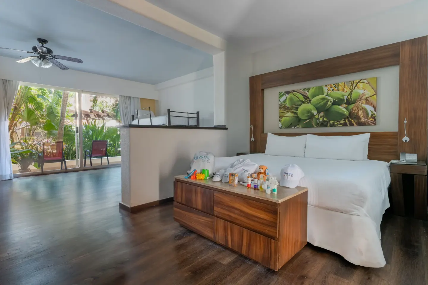 King bed guest room with terrace doors at Krystal Grand Nuevo Vallarta.