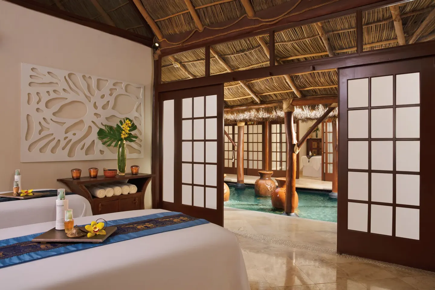 Spa treatment room with massage table and water feature at Krystal Grand Nuevo Vallarta.