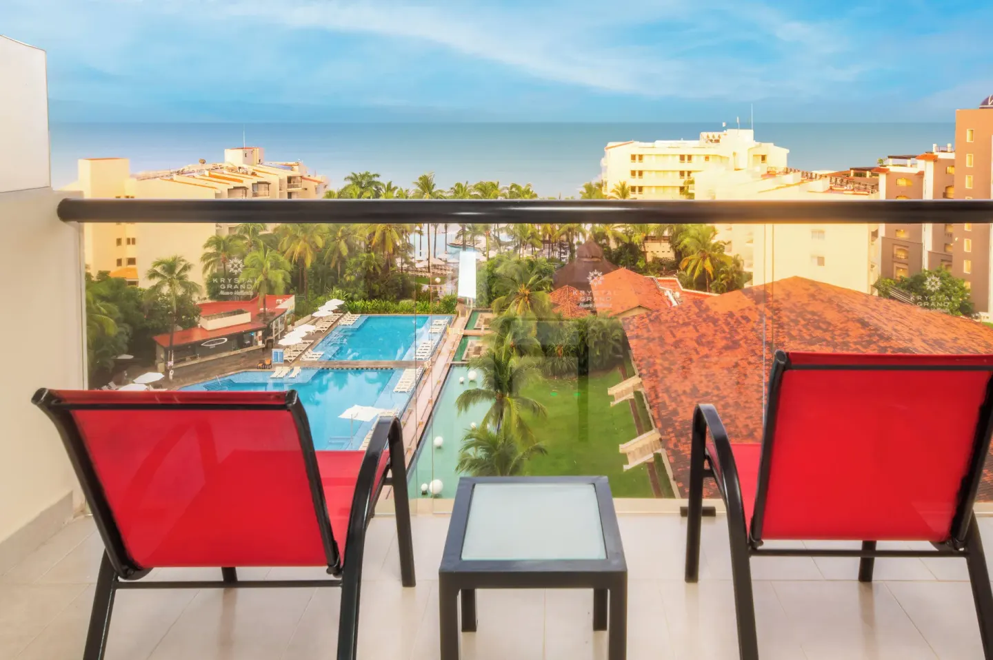 Altitude Club Junior Suite Ocean View balcony with chairs at Krystal Grand Nuevo Vallarta.