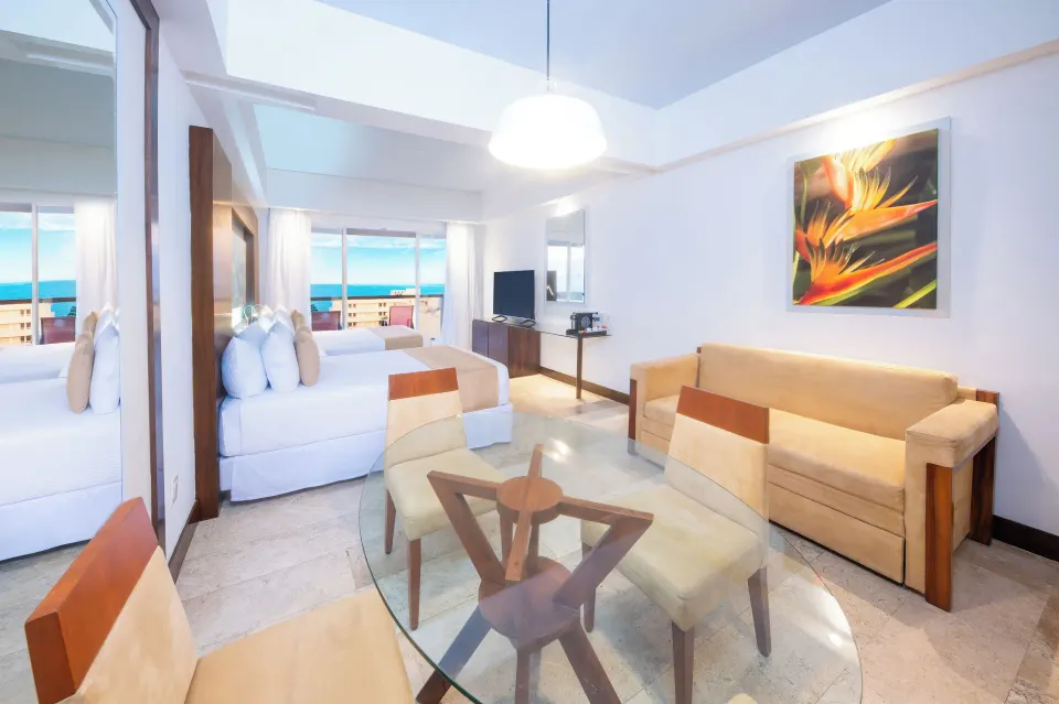 Altitude Club Junior Suite Ocean View living and king bed area at Krystal Grand Nuevo Vallarta.