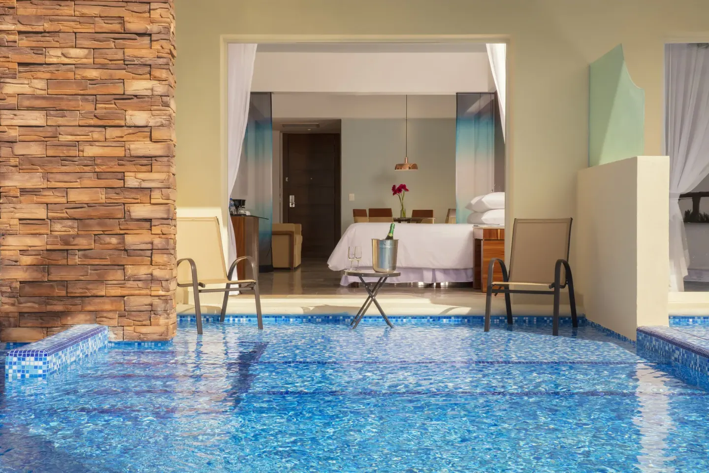 Swim-out double suite terrace with pool chairs and beds at Krystal Grand Nuevo Vallarta.