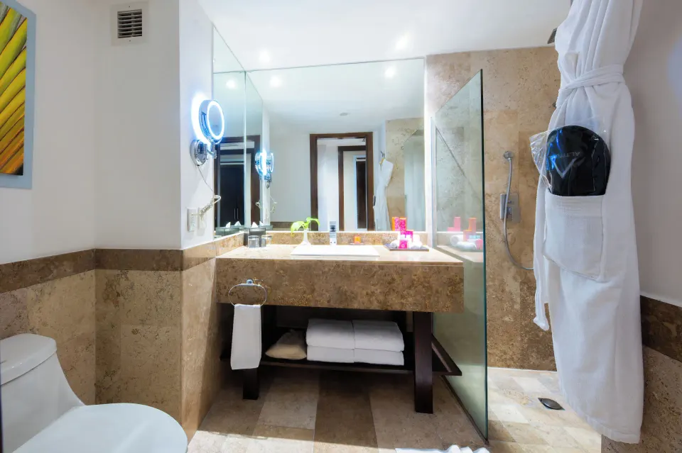 Altitude Club Junior Suite Swim Out bathroom with vanity and glass shower at Krystal Grand Nuevo Vallarta.