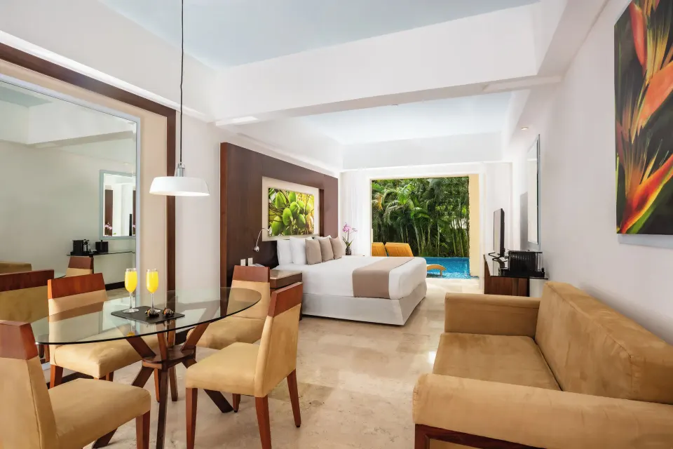 Altitude Club Junior Suite Swim Out with king bed and dining area at Krystal Grand Nuevo Vallarta.