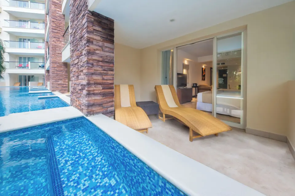 Swim-out terrace with loungers and sliding doors at Krystal Grand Nuevo Vallarta.