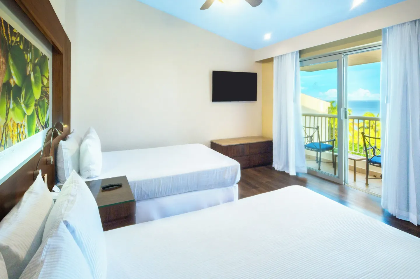 Deluxe Room Ocean View with two beds and balcony doors at Krystal Grand Nuevo Vallarta.