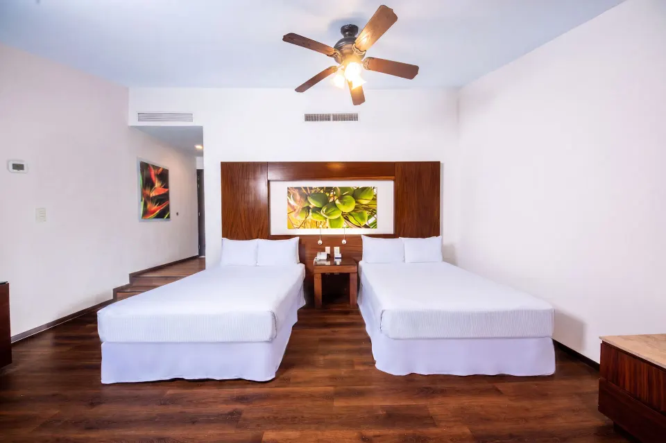 Deluxe Room Ocean View with two beds and a shared nightstand at Krystal Grand Nuevo Vallarta.