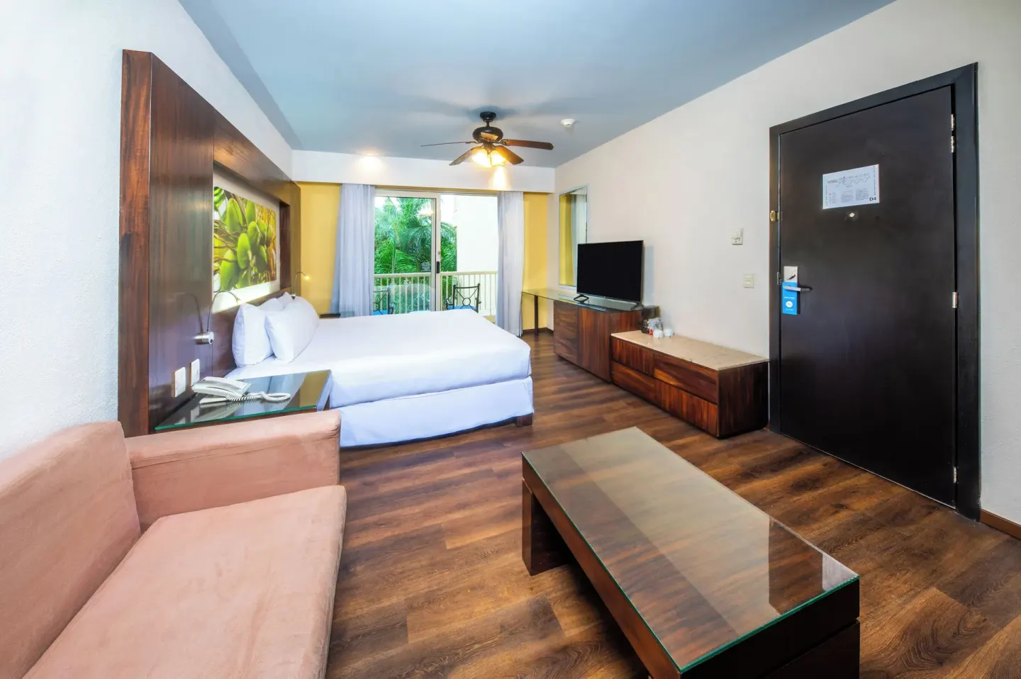 Deluxe Tropical Room View with king bed, sofa, and TV at Krystal Grand Nuevo Vallarta.
