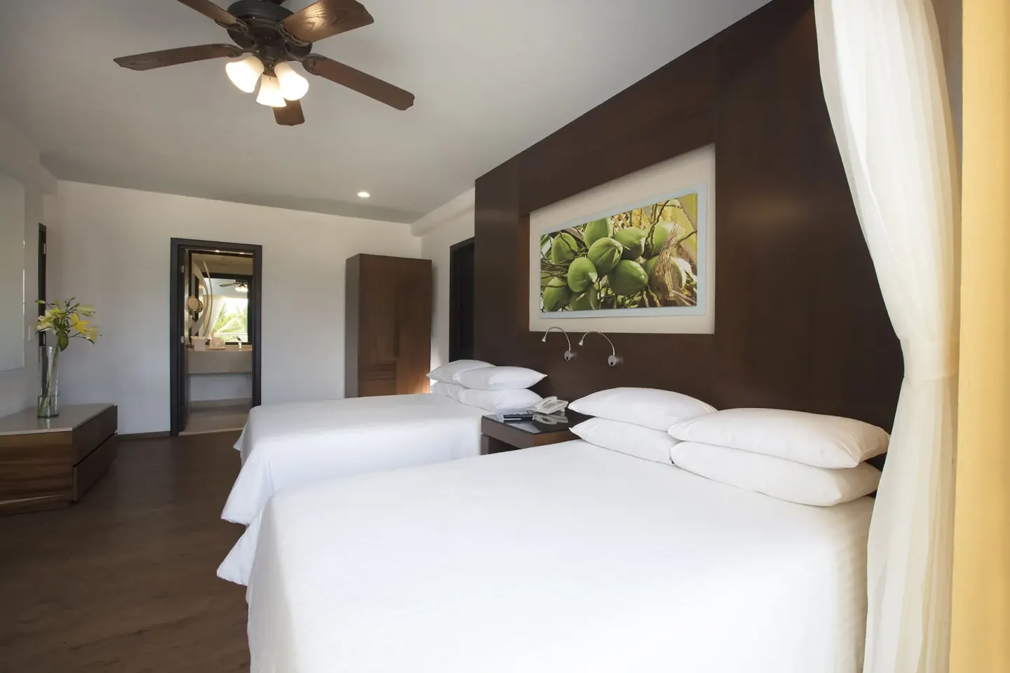 Two-bed Deluxe Tropical View Doble room with ceiling fan at Krystal Grand Nuevo Vallarta.