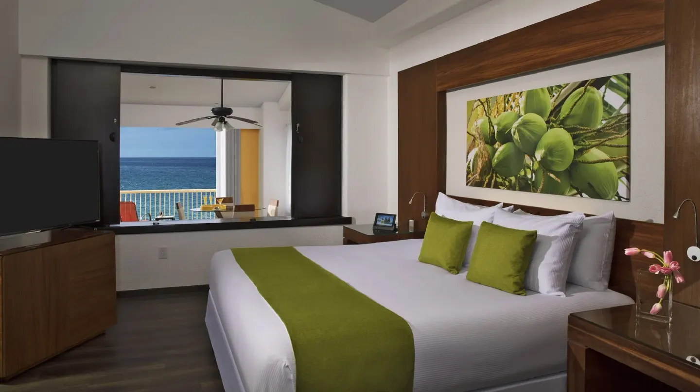 Junior Suite Ocean Front king bed with TV and ocean balcony at Krystal Grand Nuevo Vallarta.