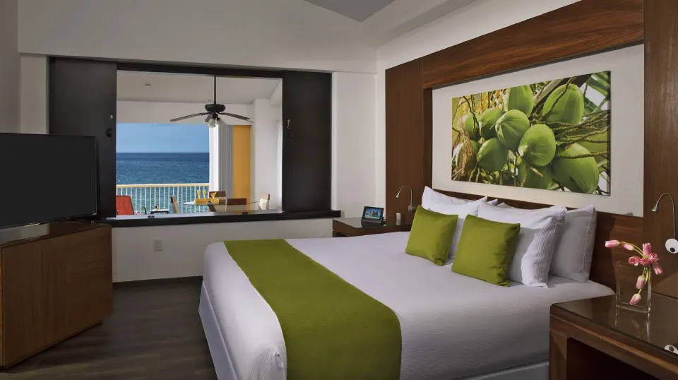 Junior Suite Ocean Front king bed with TV and ocean balcony at Krystal Grand Nuevo Vallarta.