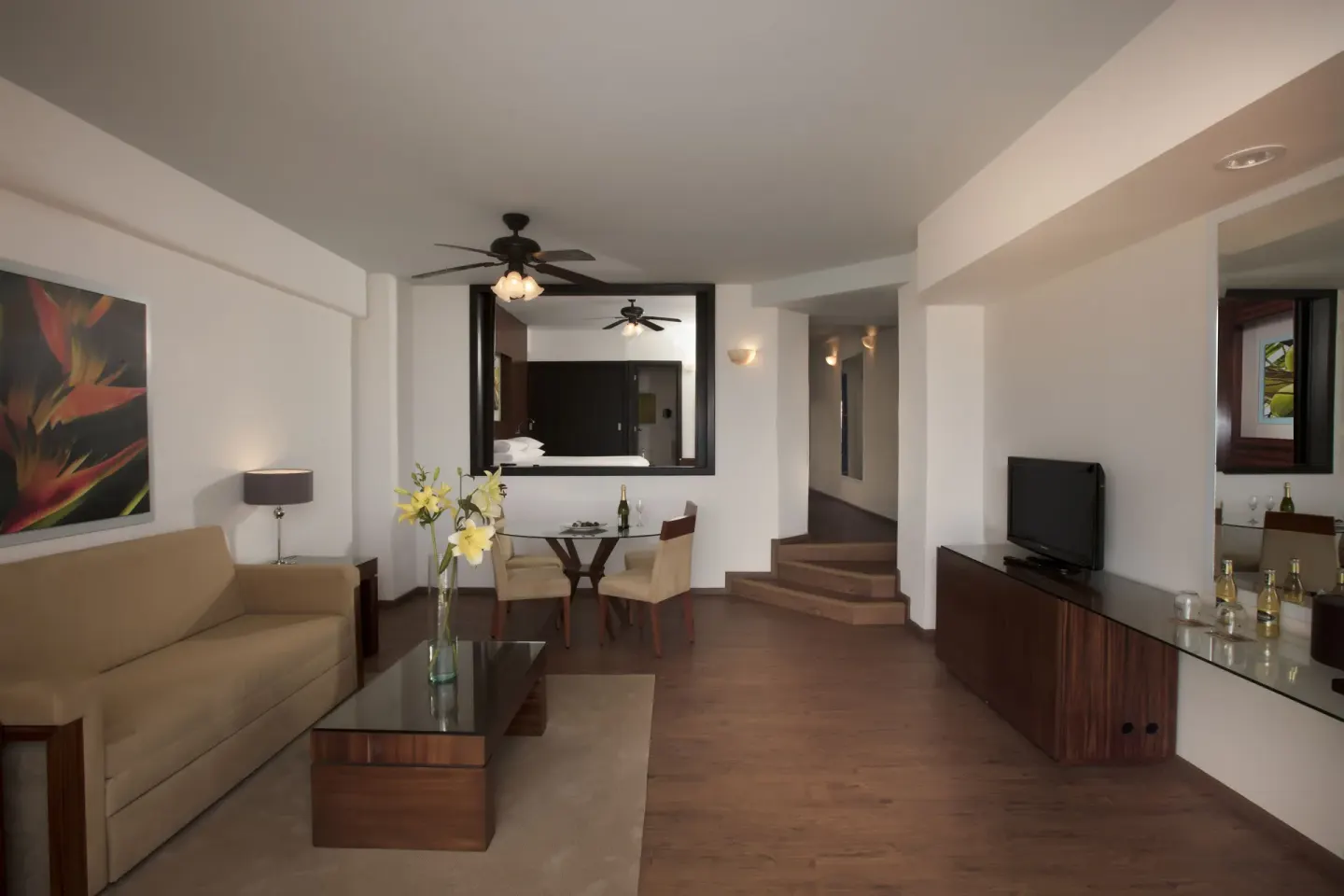 Junior Suite Ocean Front living area with sofa and dining table at Krystal Grand Nuevo Vallarta.