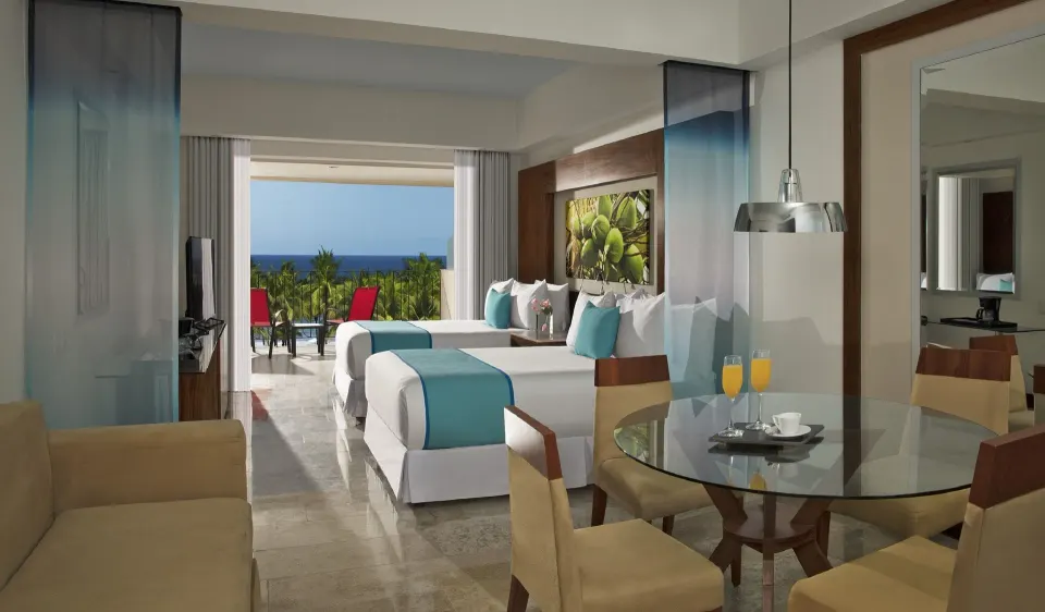 Junior Suite Ocean View double beds with balcony seating at Krystal Grand Nuevo Vallarta.