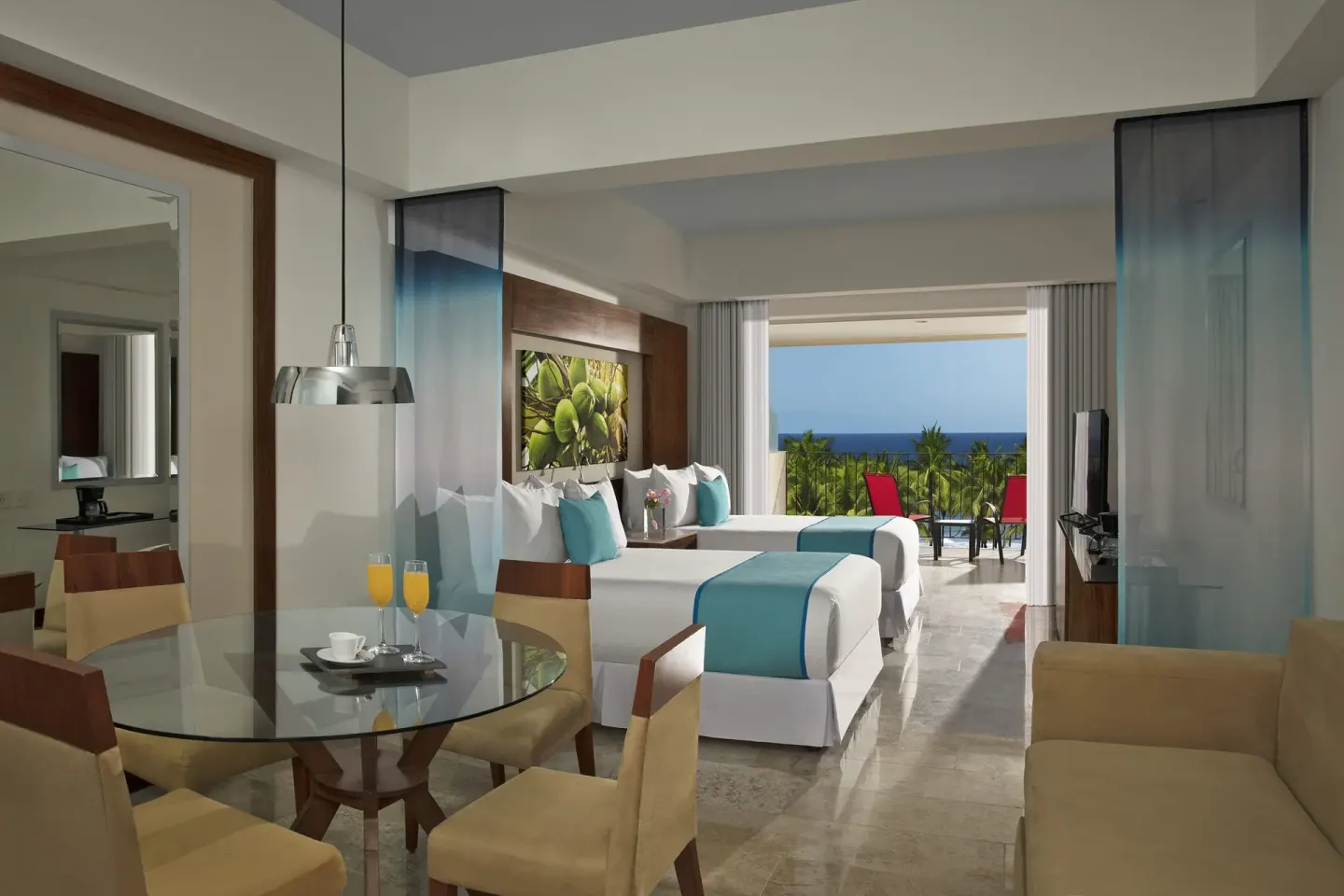 Junior Suite Ocean View double room with dining table and balcony at Krystal Grand Nuevo Vallarta.
