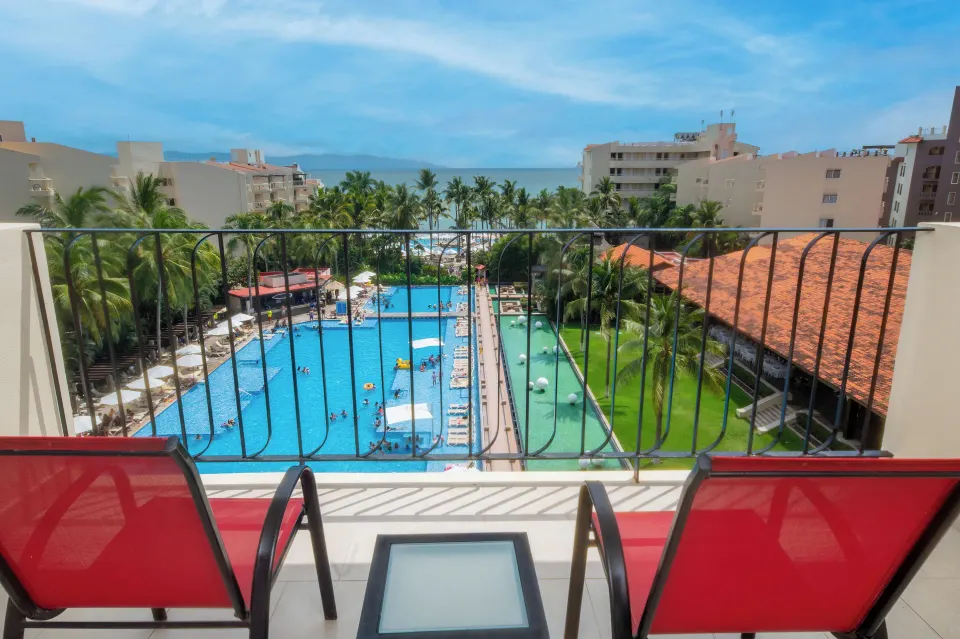Junior Suite Ocean View balcony with red chairs at Krystal Grand Nuevo Vallarta.
