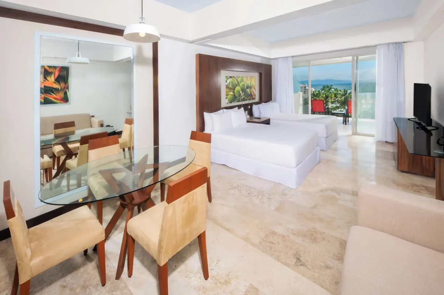 Junior Suite Ocean View with king bed and dining table at Krystal Grand Nuevo Vallarta.