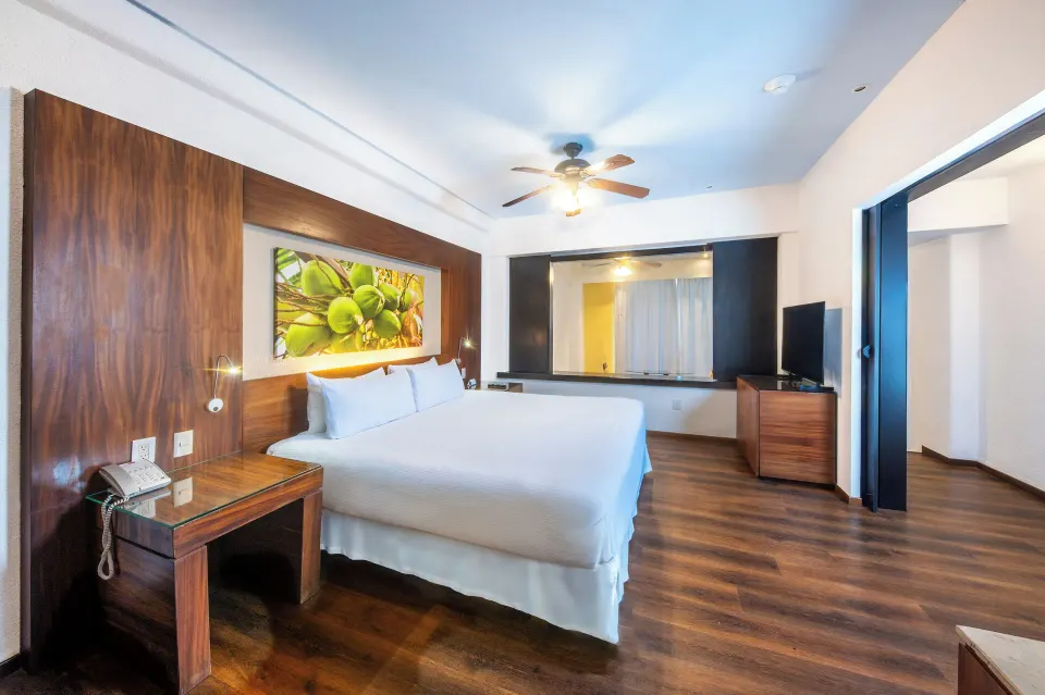 Junior Suite Ocean View king bed with wood flooring at Krystal Grand Nuevo Vallarta.