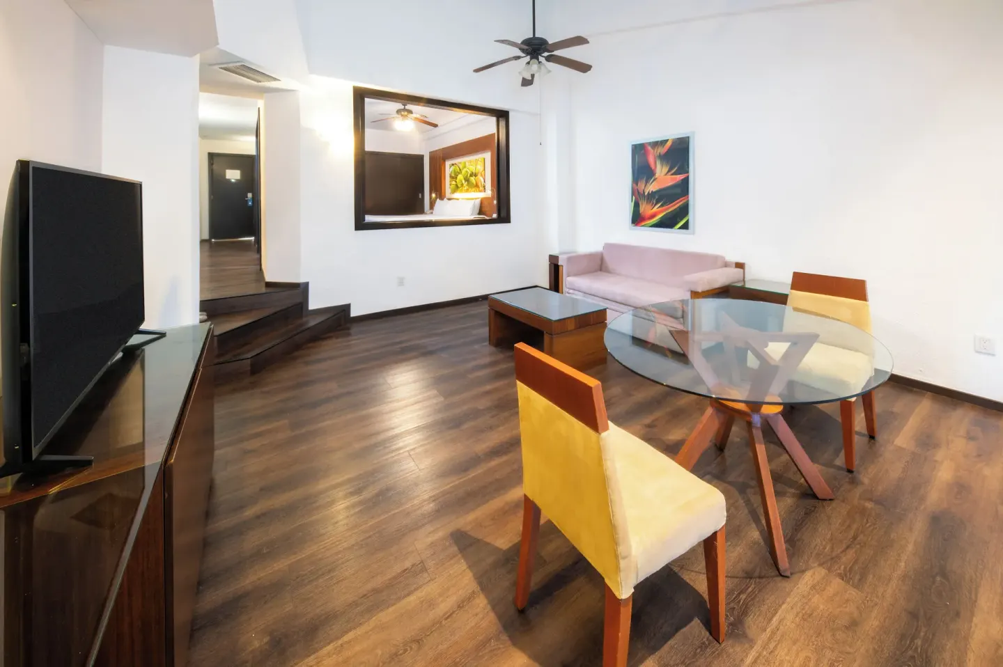 Junior Suite Ocean View living area with sofa and dining table at Krystal Grand Nuevo Vallarta.