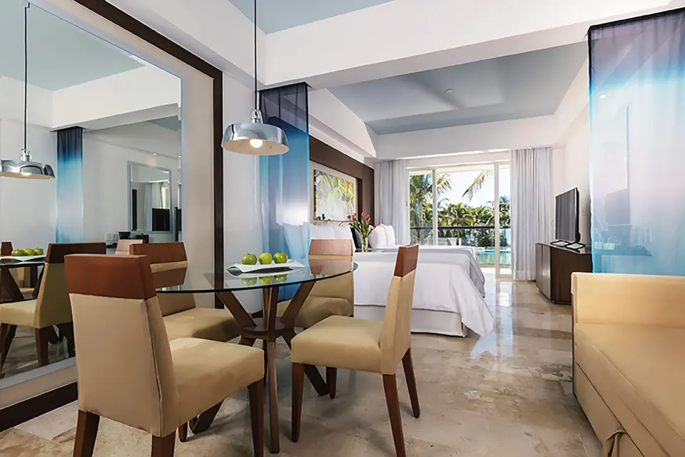 Junior Suite Pool View Doble with two beds and dining table at Krystal Grand Nuevo Vallarta.