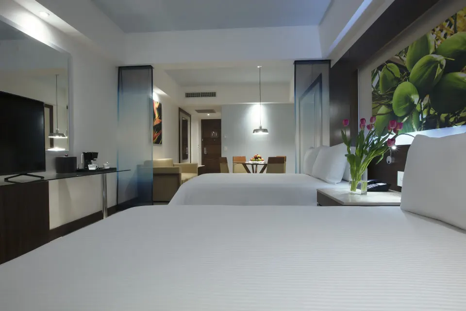 Two beds and TV in a Junior Suite Pool View Doble at Krystal Grand Nuevo Vallarta.