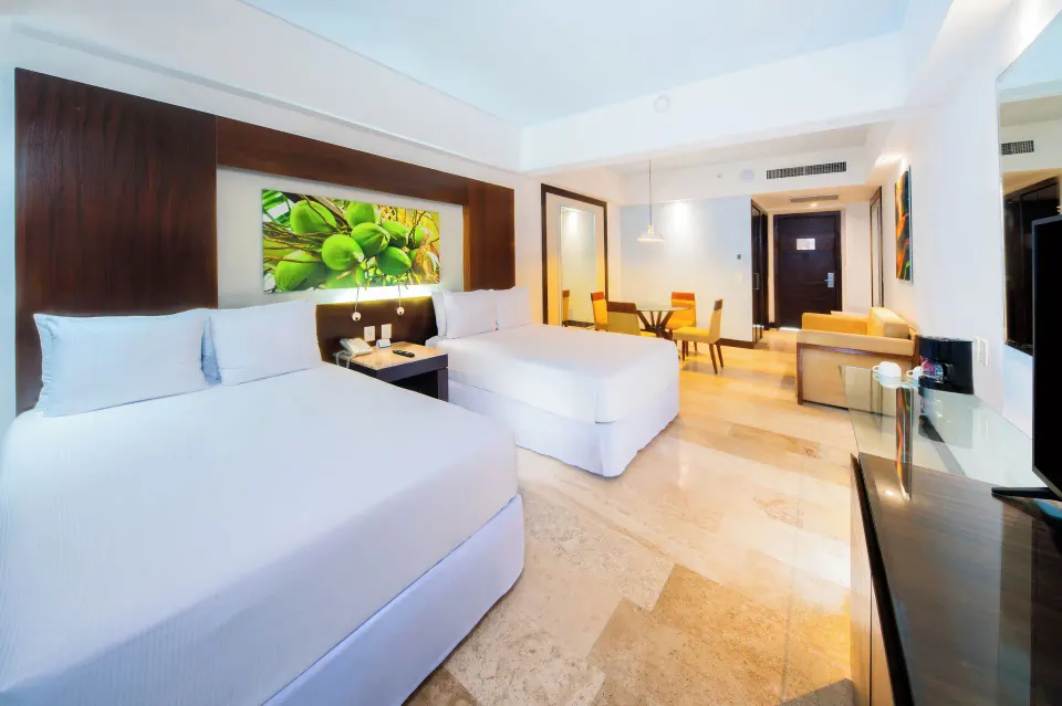 Junior Suite Pool View with two beds and seating at Krystal Grand Nuevo Vallarta.