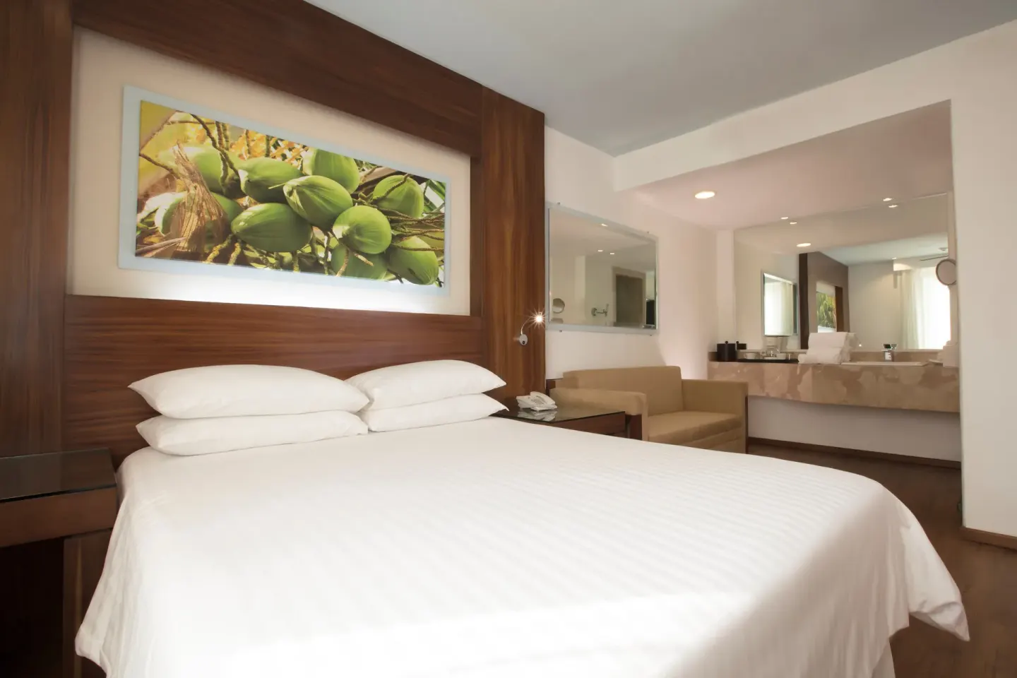 Standard room king bed facing an open vanity area at Krystal Grand Nuevo Vallarta.