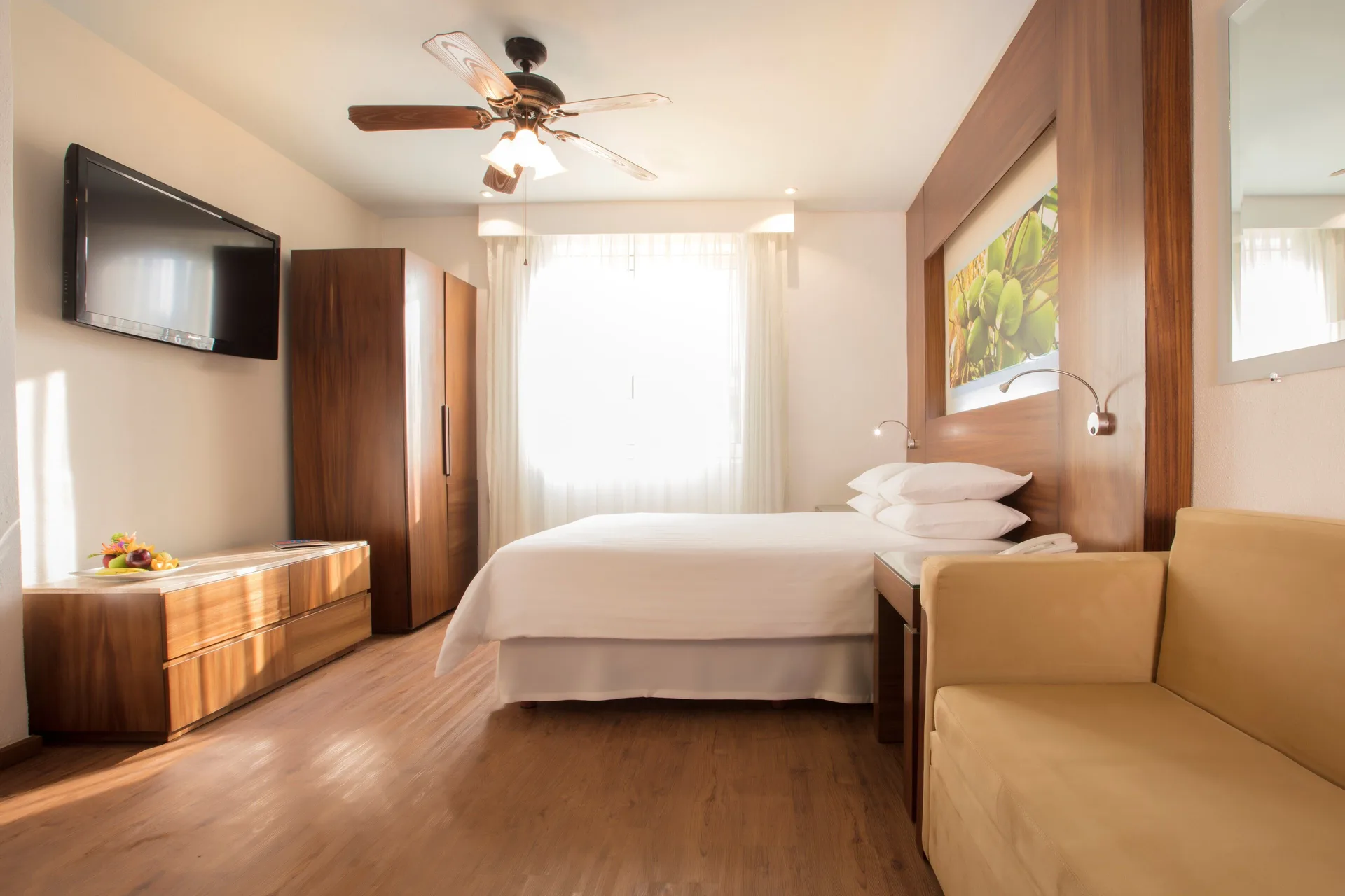 Standard Resort View Room with king bed, TV, and sofa at Krystal Grand Nuevo Vallarta.