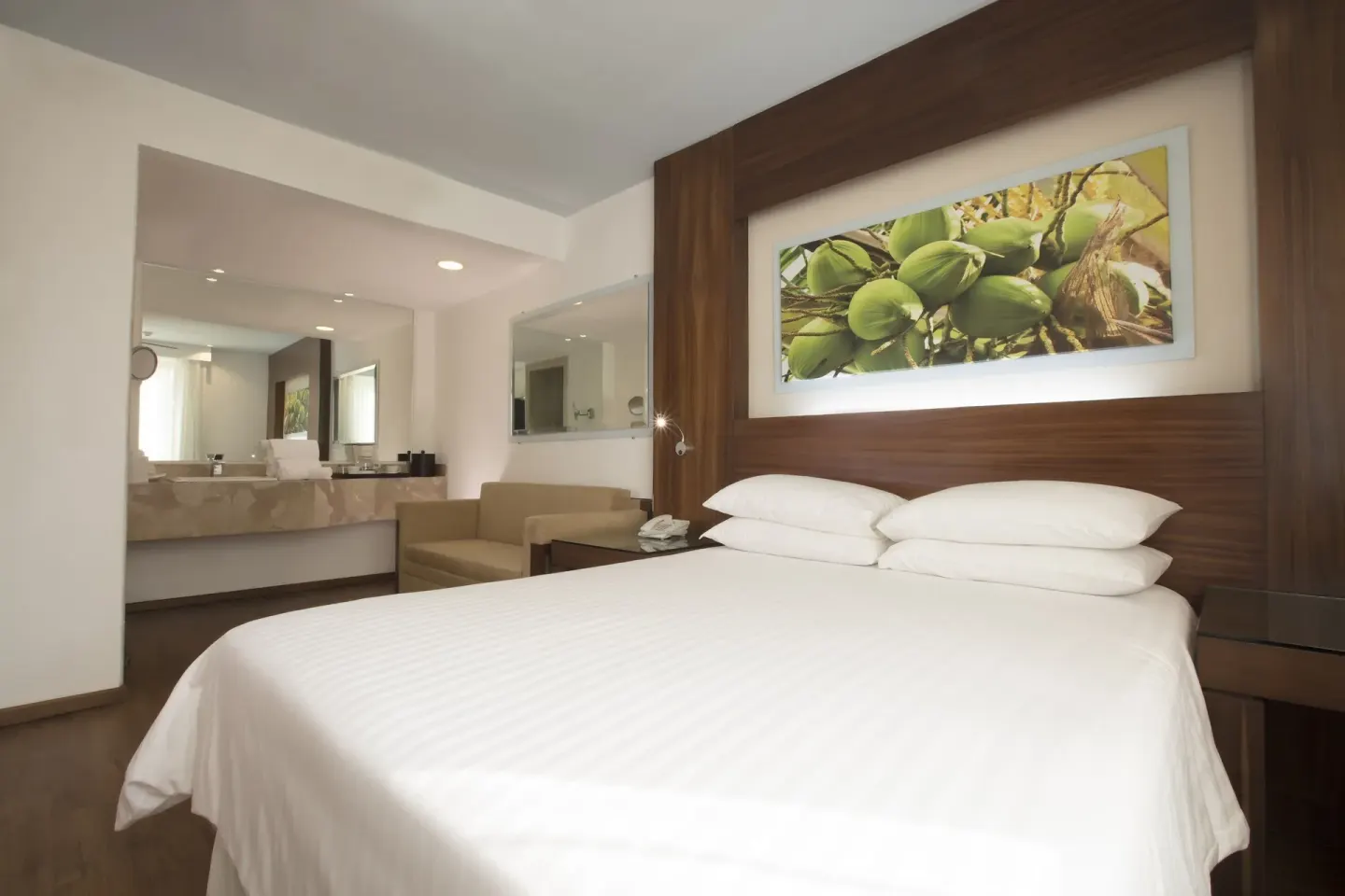Standard room king bed with open vanity area at Krystal Grand Nuevo Vallarta.