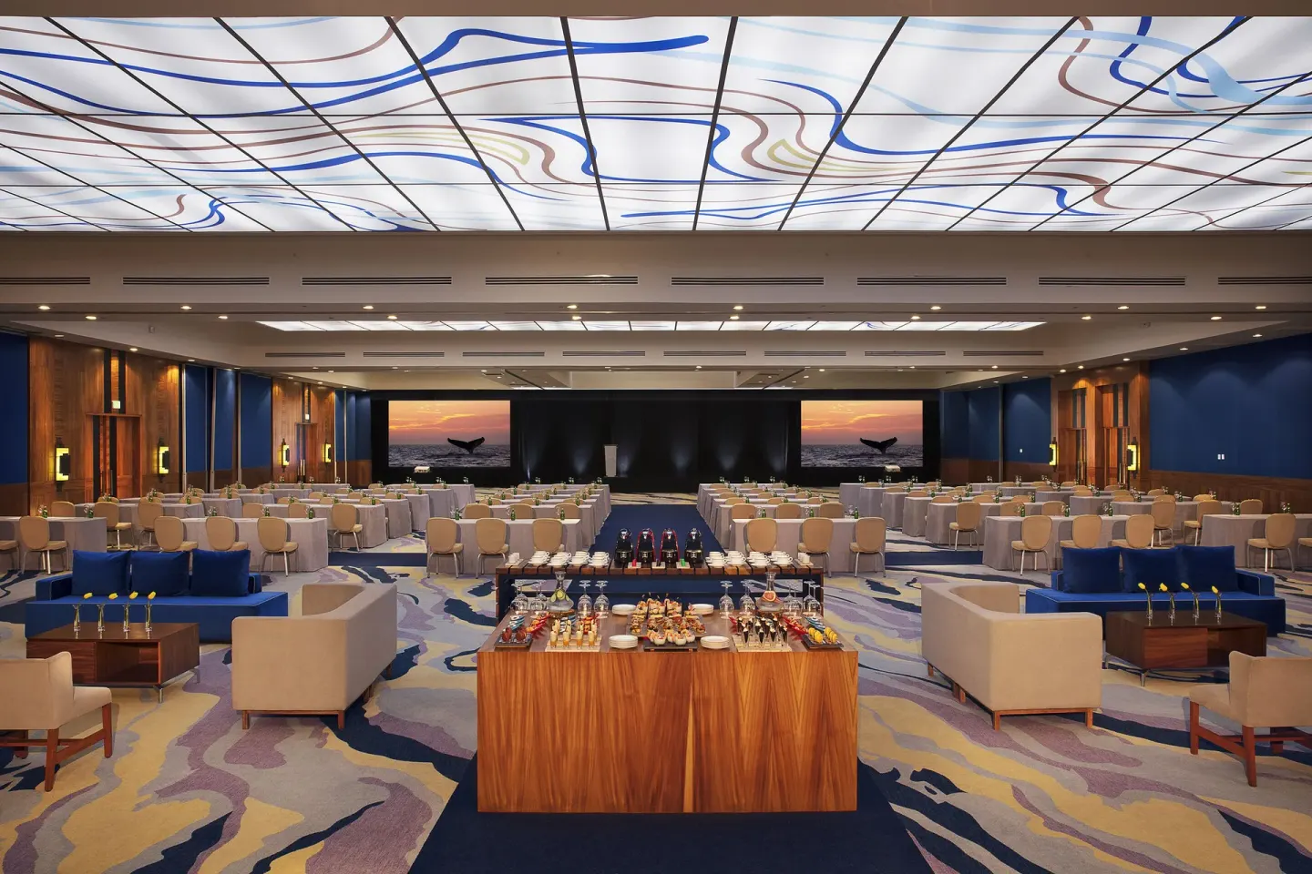 Banquet room with round tables and lounge seating at Krystal Grand Nuevo Vallarta.