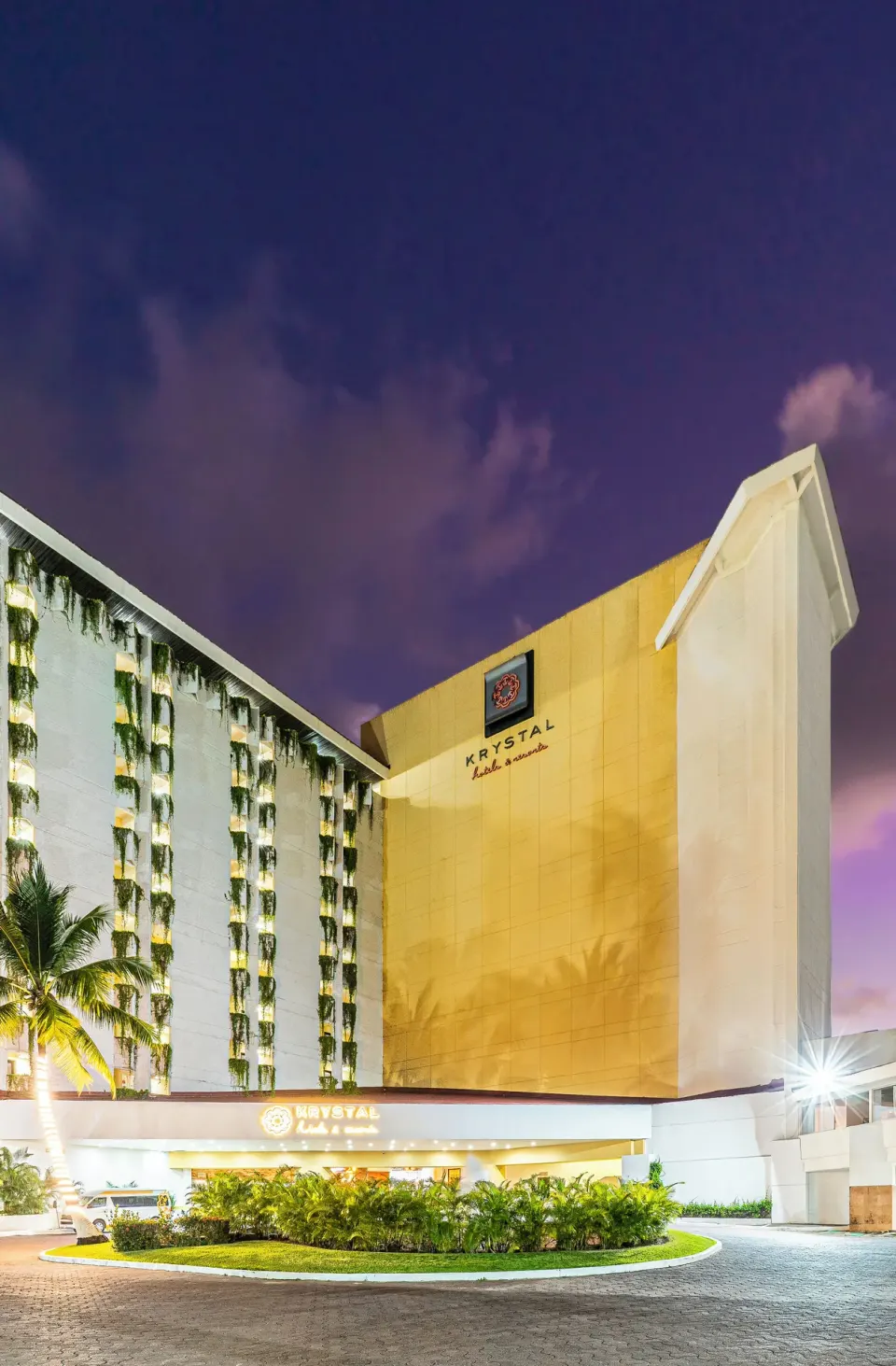 Illuminated hotel exterior and entrance at night at Krystal Ixtapa.