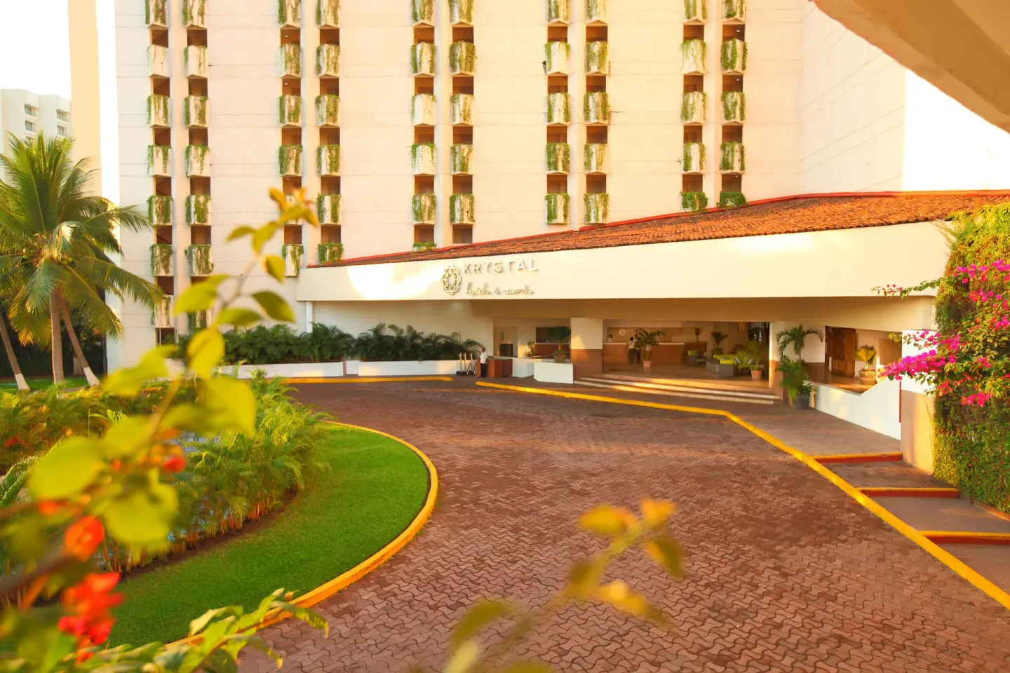 Landscaped entrance drive and open lobby approach at Krystal Ixtapa.
