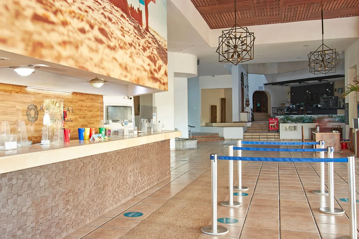 Lobby counter with queue barriers and pendant lights at Krystal Ixtapa.