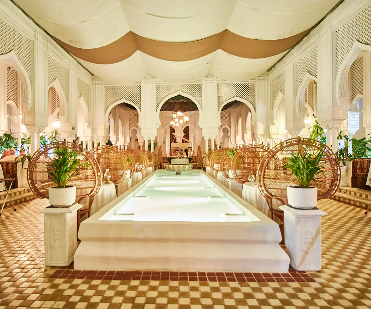 Moroccan-style dining room with arched details and a central water feature at Krystal Ixtapa.