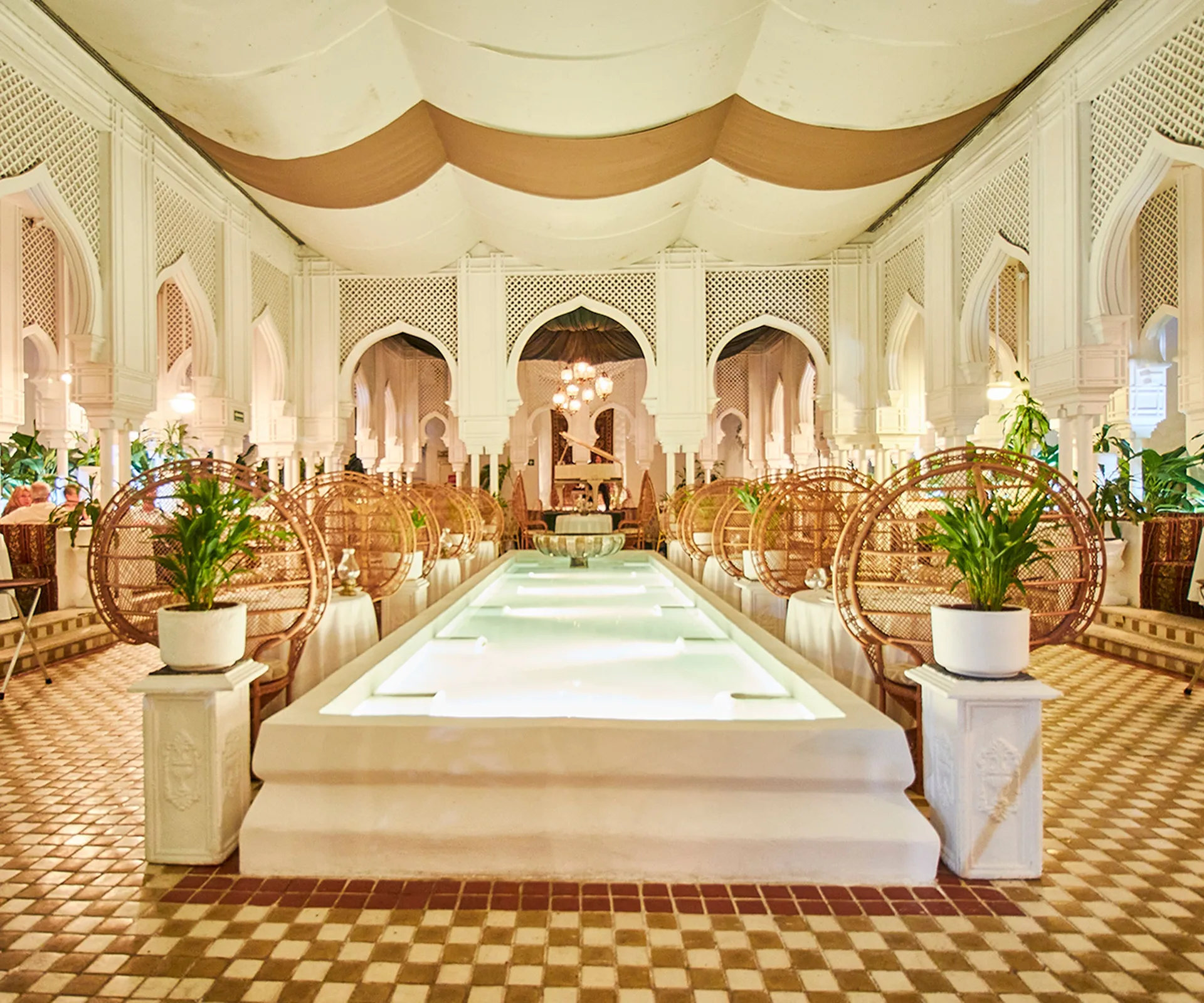 Moroccan-style dining room with arched details and a central water feature at Krystal Ixtapa.