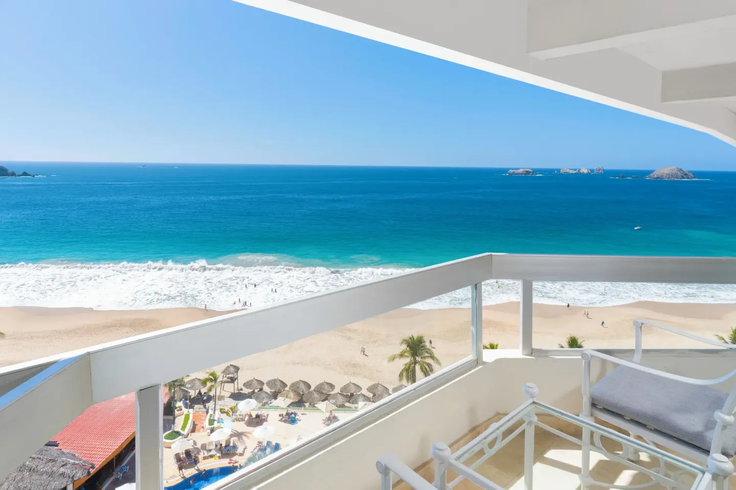 Ocean View room balcony with lounge seating and direct beach view at Krystal Ixtapa.