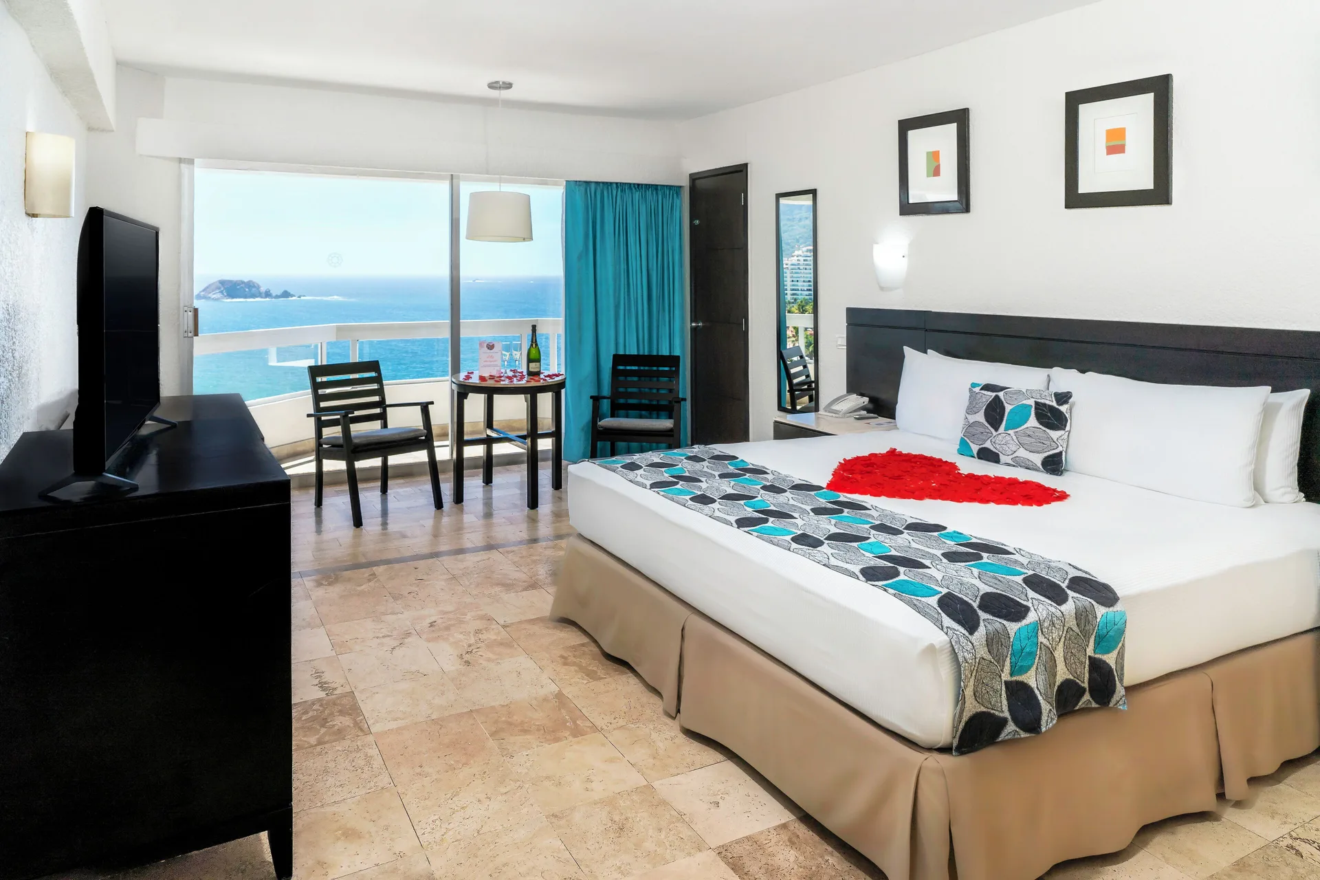 Ocean View room with king bed, seating area, and balcony sea view at Krystal Ixtapa.