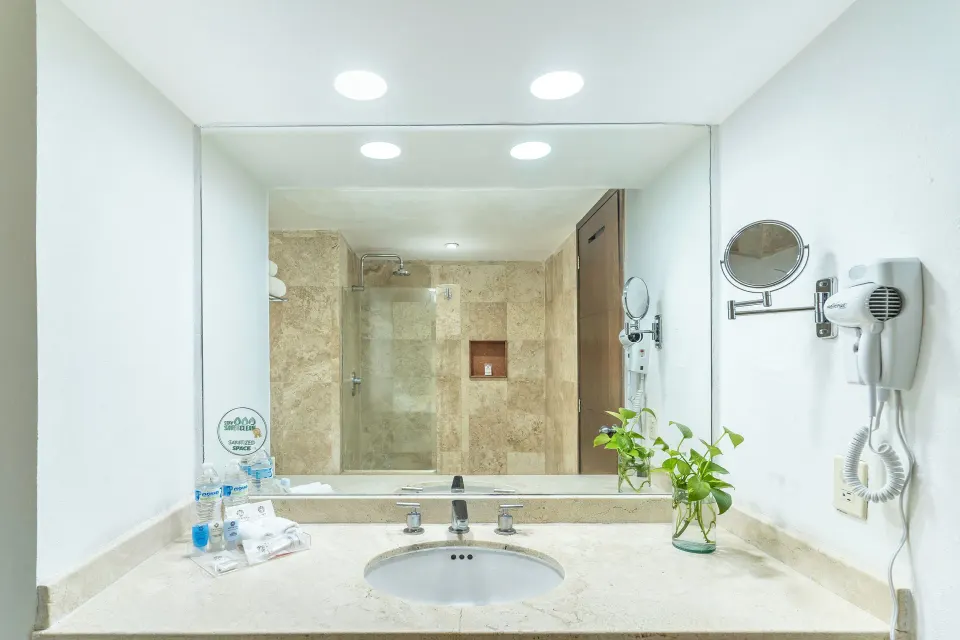 Standard Room Garden View bathroom vanity with mirror and sink at Krystal Ixtapa.