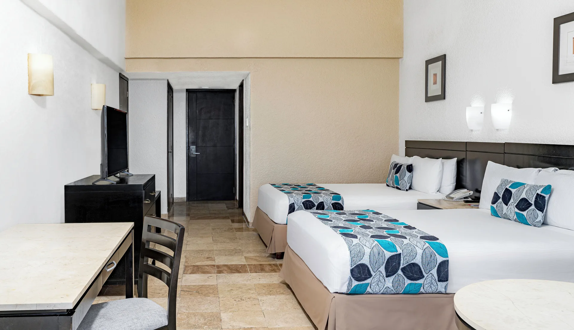 Standard Room Garden View with two beds, TV and desk at Krystal Ixtapa.
