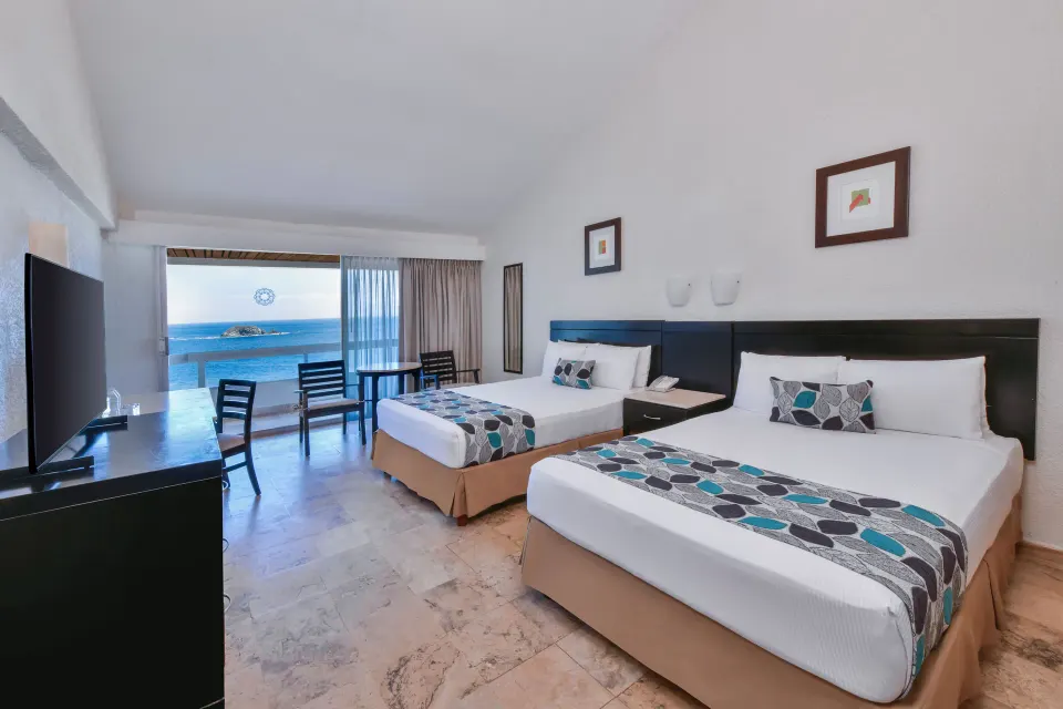 Standard Room Sea View with two beds, TV, and balcony view at Krystal Ixtapa.