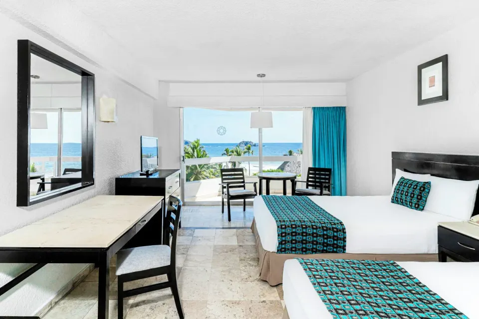 Standard Room Sea View with two beds, desk, mirror, and balcony at Krystal Ixtapa.