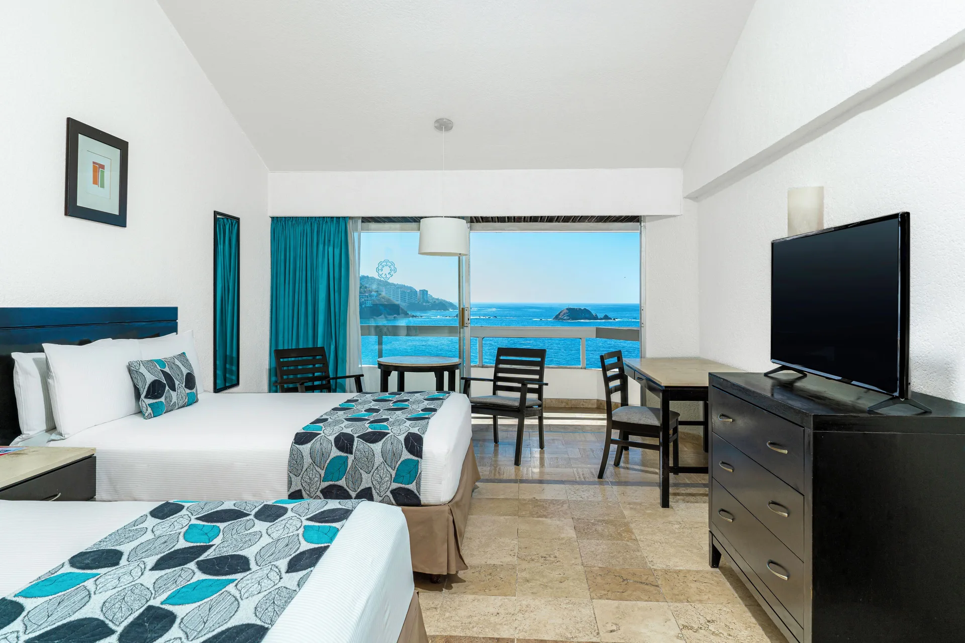 Standard Room Sea View with two beds and ocean-facing window at Krystal Ixtapa.