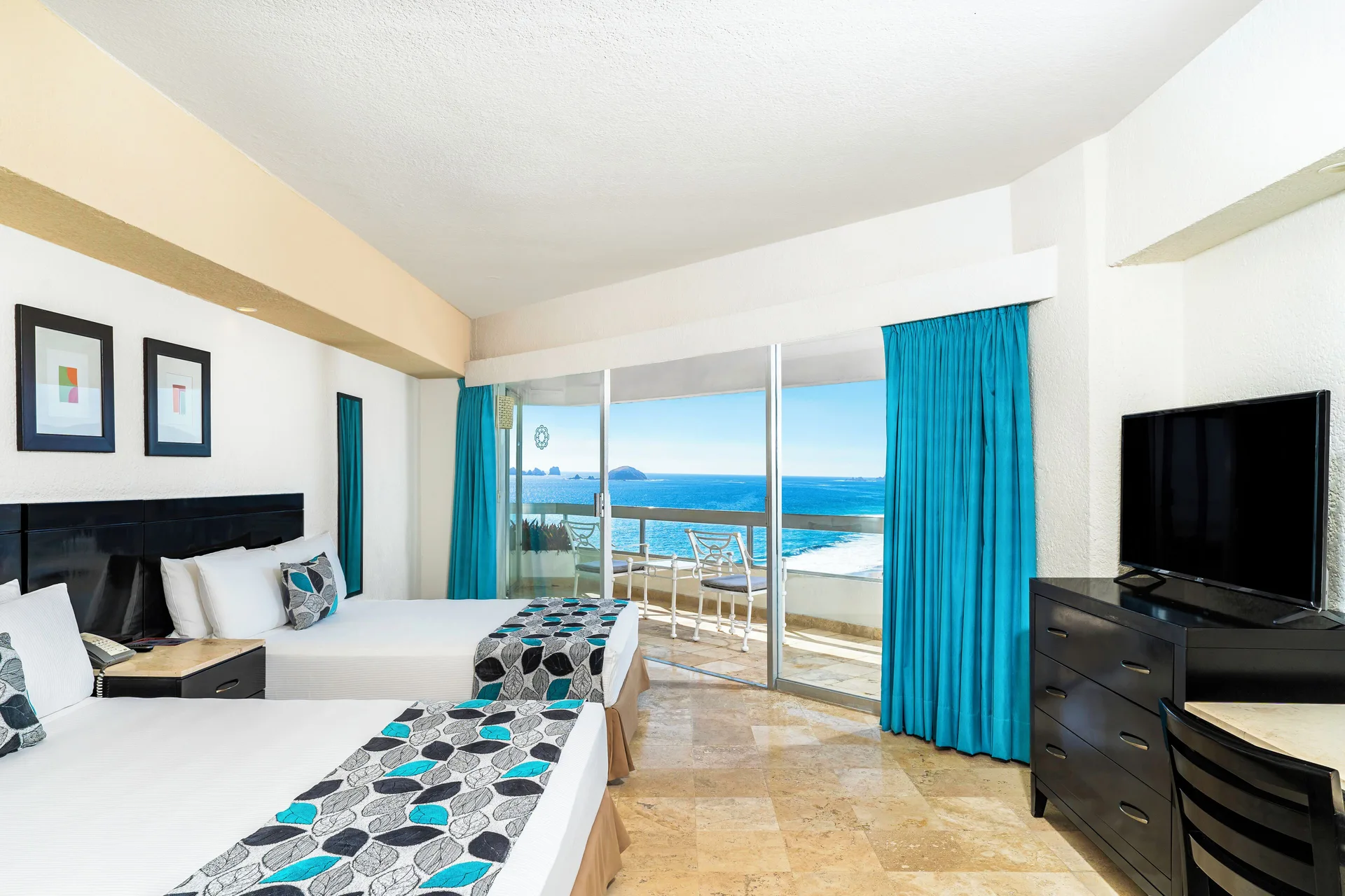 Superior Sea View room with two beds, balcony, ocean view, and TV at Krystal Ixtapa.
